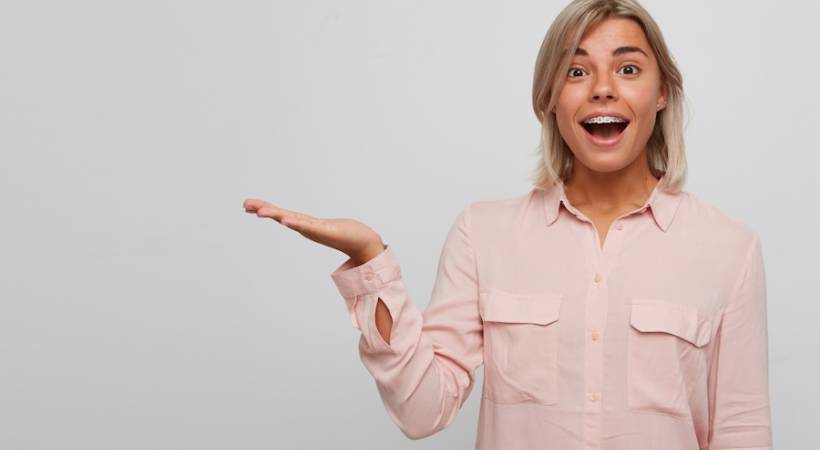 woman-with-braces-smiling-mouth-opened-hand-stretch