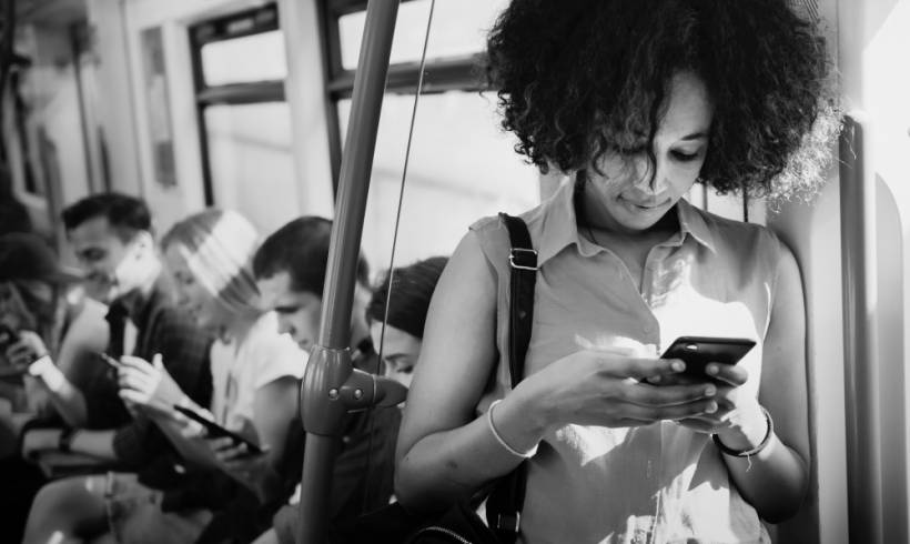 young-woman-using-smartphone-subway-dark-social-impact-businesses