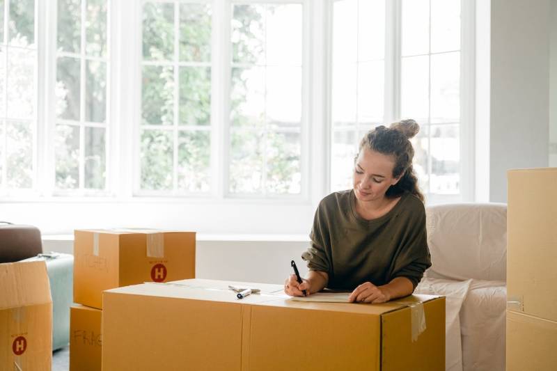 woman packing before moving back home