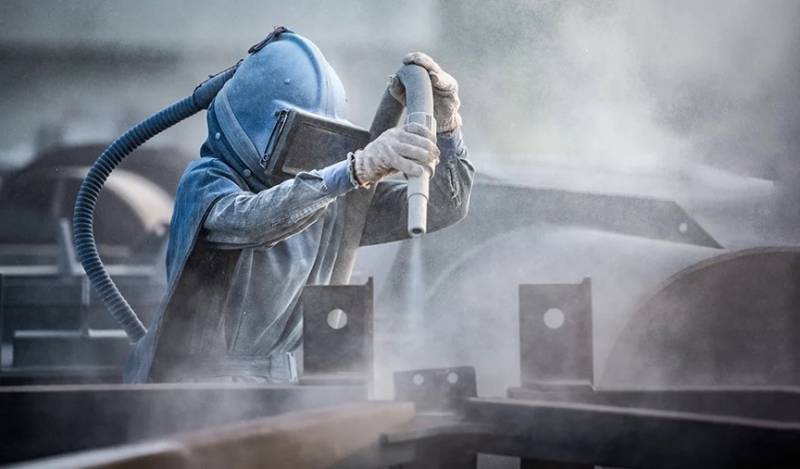 Abrasive blasting operator at work Image for