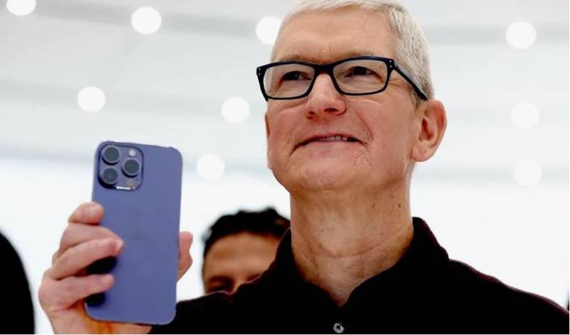 Apple CEO Tim Cook holding iPhone 15