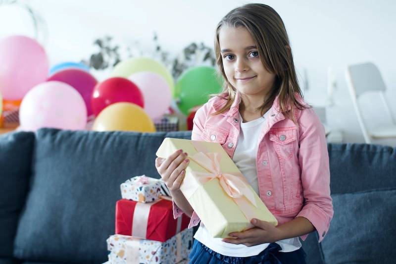 Girl in Pink Jacket Holding a Gift