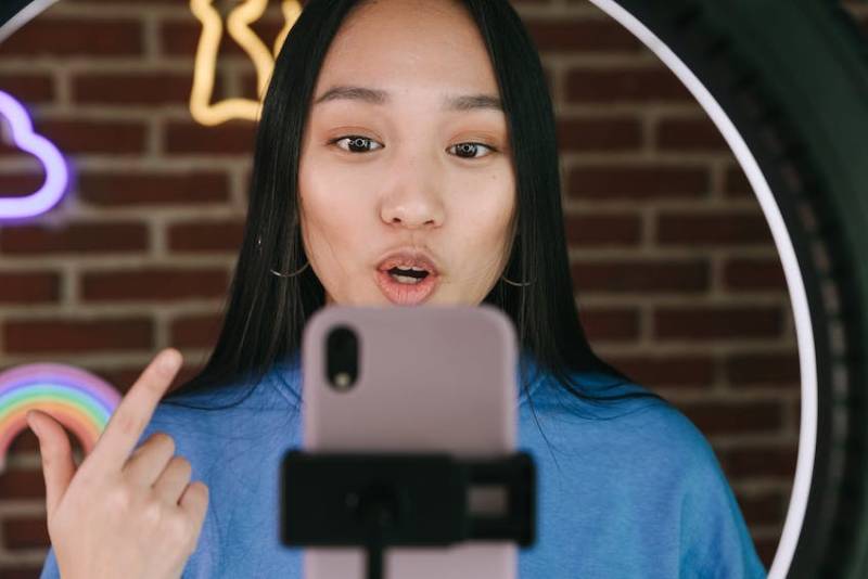 Woman Influencer Recording Herself with a Smartphone