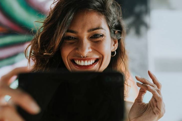 woman-smiling-using-laptop-apps-for-creative-pro