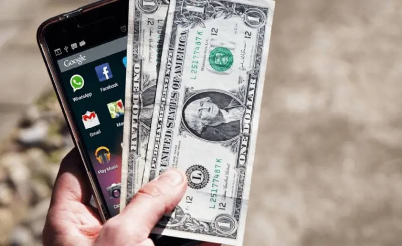 Smartphone and Dollar Bills Image for App Monetization Trends You Should Not Ignore