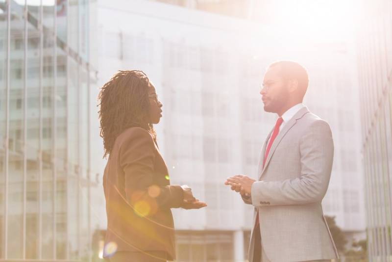 Improving Gender Equality: Firms Must Do More Than Virtue Signaling business_man_woman_ colleagues_discussing_gender equality