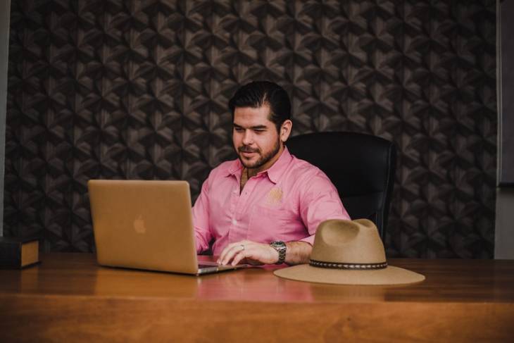 businessman-sitting-at-desk-with-laptop-monitoring-website-changes