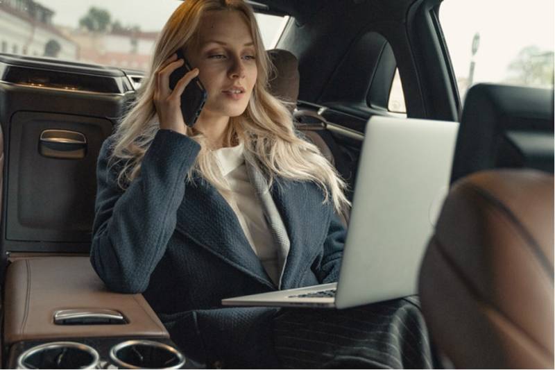 businesswoman-car-backseat-laptop-working-business-travel