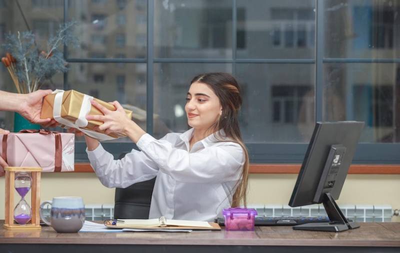 Businesswoman Entrepreneur Taking Present Gift Box In Office Image for Gift Ideas for Entrepreneurs