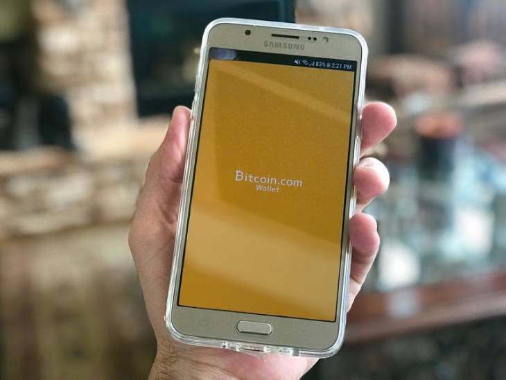 How Cryptocurrency Has Changed the Future of Digital Payments hand-holding-smartphone-cryptocurrency-changed-digital-payments - illustration