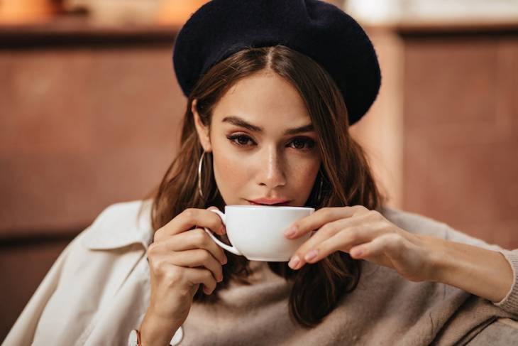 elegant-young-woman-drinking-coffee-from-white-cup