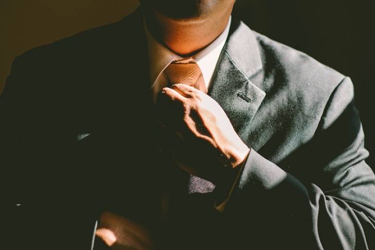man-suite-adjusting-tie-era-of-the-entrepreneur