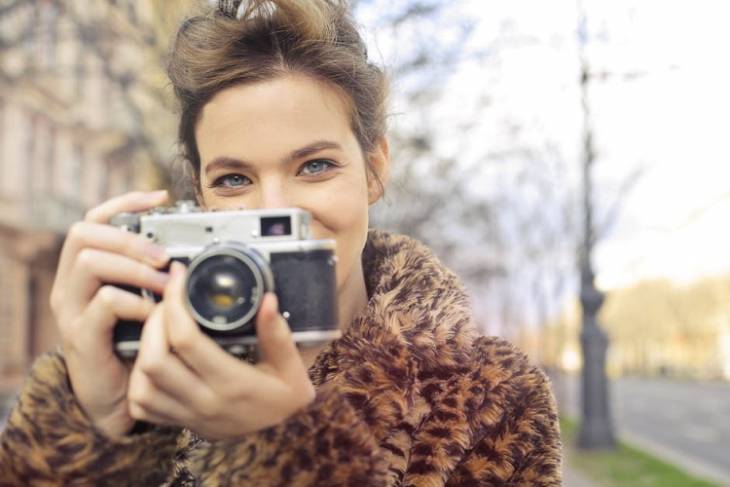 woman-female-photographer-holding-camera-smiling-best-free-stock-photo-websites