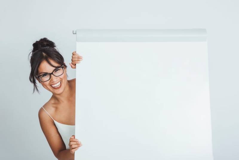 happy-businesswoman-hiding-whiteboard