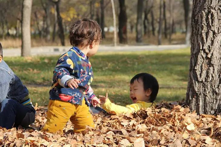 happy-kids-playing-autumn-nature - How Nature Impacts Children’s Well-Being Illustration