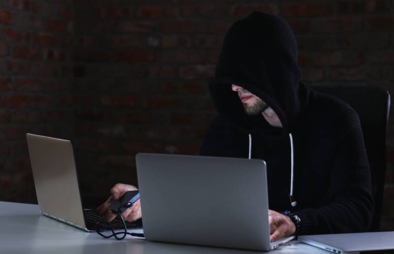 man-hacker-laptop-ai-scam-alert