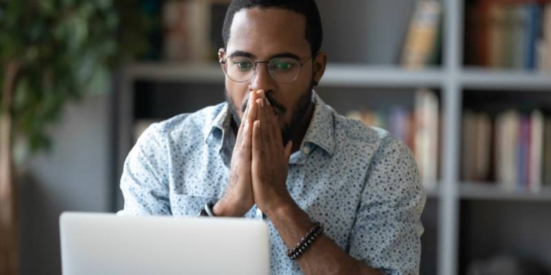 man-laptop-surprised-money-transfer-fraud