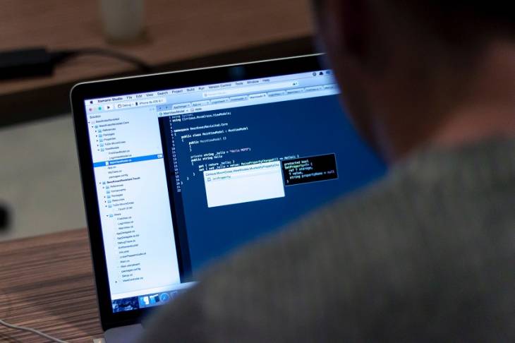 5 Ways to Practice Coding Using JavaScript man-using-laptop-practice-coding-using-javascript