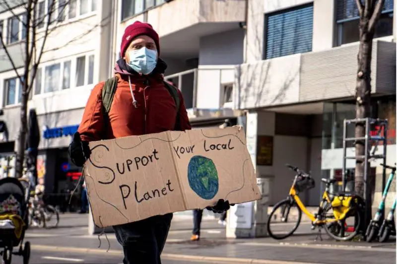 man-protester-carrying-protet-planet-sign