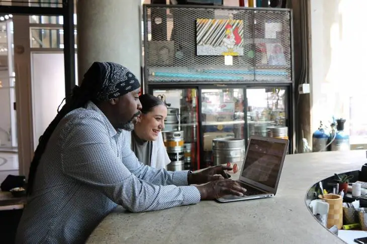 man-woman-laptop-working-with-investors