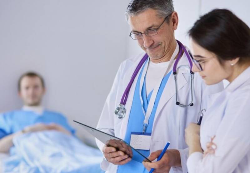 medical team of doctors man and woman checking healthcare records