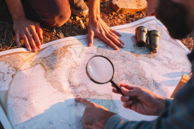 How to Start a Treasure Hunting Business and Make Good Money men-exploring-map-treasure-hunting