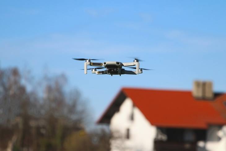 drone-flying-over-house-micro-camera-applications-in-industries