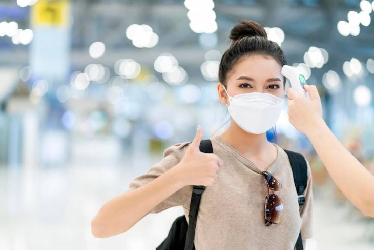 woman-wearing-covid-mask-airport-terminal