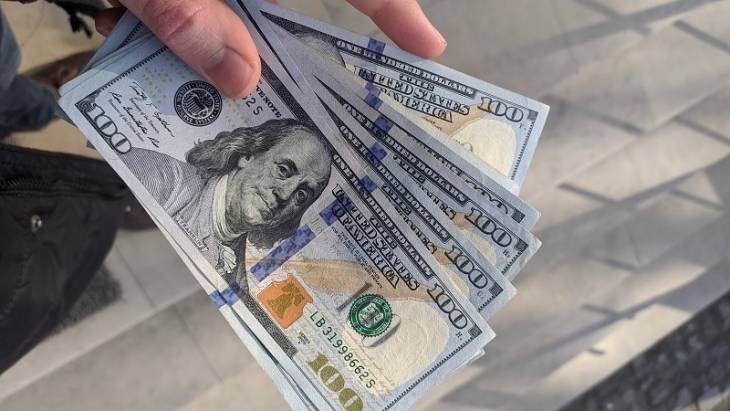 hand-holding-dollar-notes-improve-financial-health