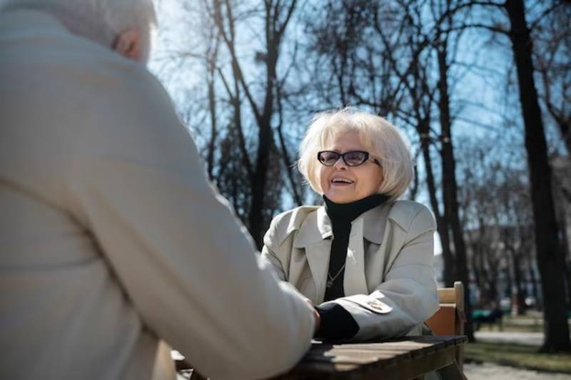 senior-people-holding-hands-side-view-happy