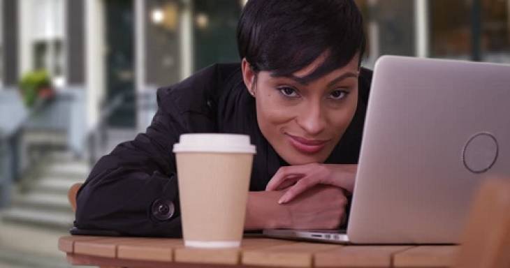 woman-laptop-coffee-cup-looking-ahead-tendency-to-procrastinate