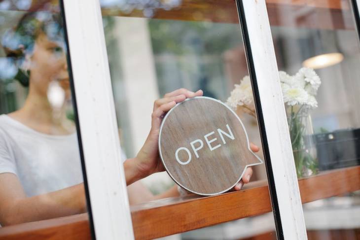 woman-business-owner-open-for-business-sign
