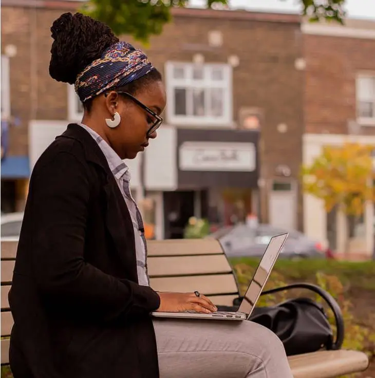 woman-writing-using-laptop-outside