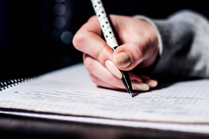female-hand-holding-pen-writing-longhand
