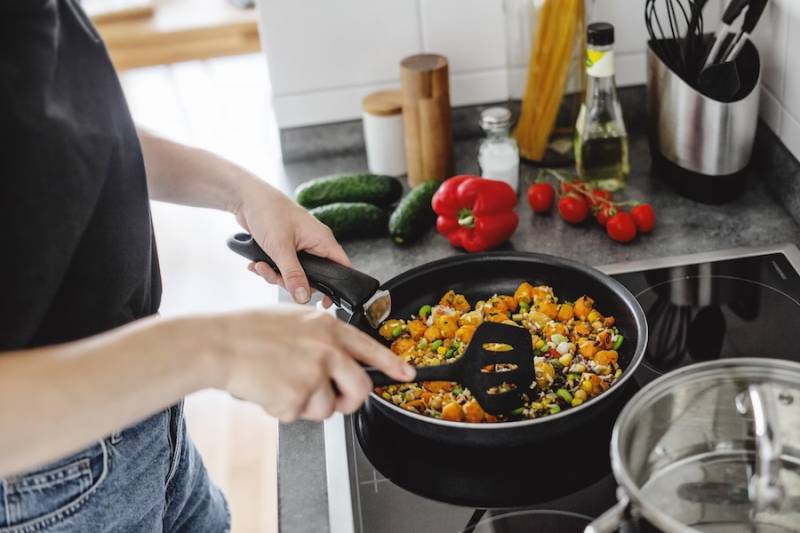 young-woman-cooking-pan-sauteing