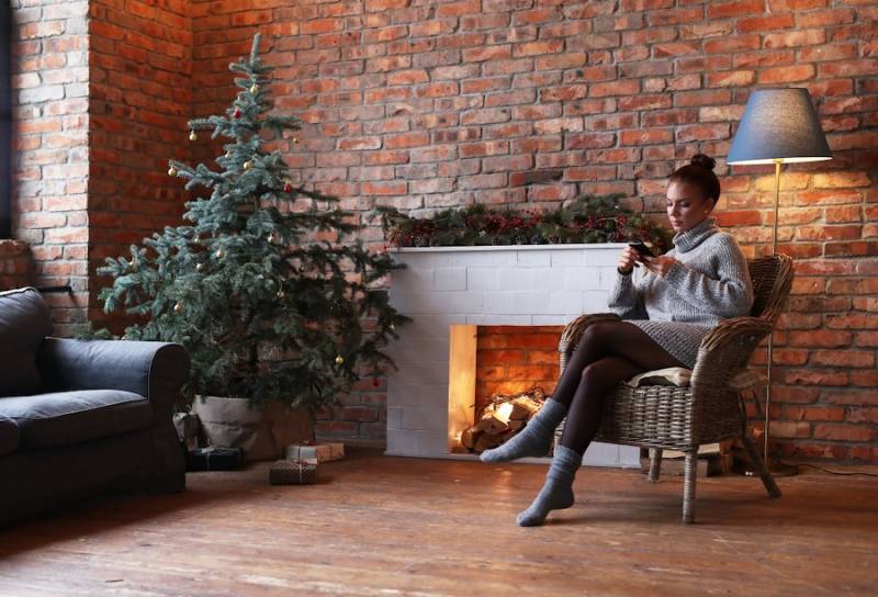 How Property Managers Can Protect Tenants During Holidays young-woman-using-smartphone-home