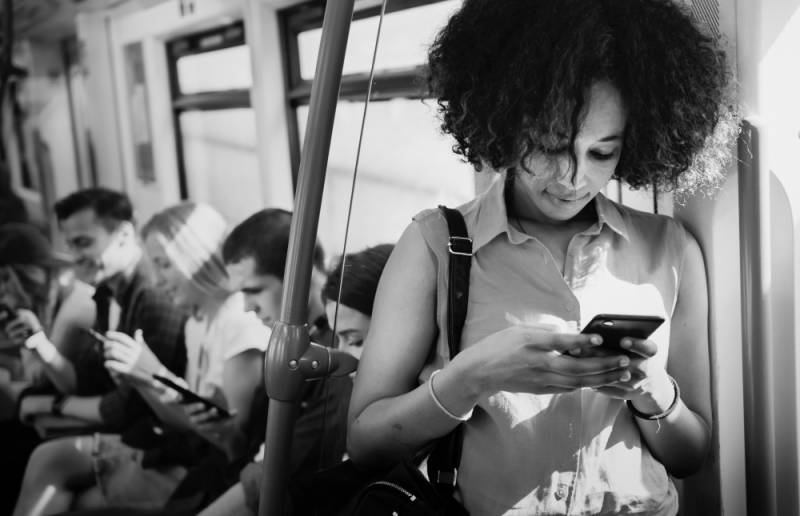 young-woman-using-smartphone-subway-dark-social-impact-businesses