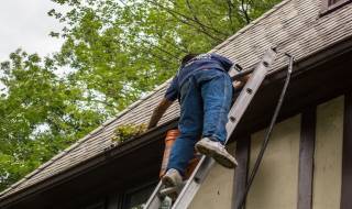 man-cleaning-gutter