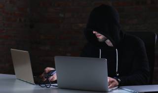 man-hacker-laptop-ai-scam-alert