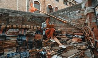 woman-reading-book-sitted-on-pile-of-books-literature-city