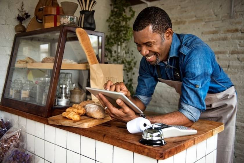 man-small-business-owner-using digital tablet ai adoption