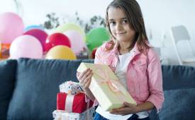 Girl in Pink Jacket Holding a Gift