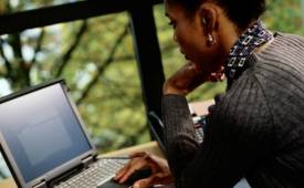 Woman_Using_laptop_writing_importance_of_Critical_Thinking_When_Writing - Illustration