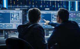 IT-team-pointing-computer-screen-ai-cybersecurity-threats
