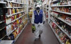 man-protective-gear-disinfection-ailes-supermarket-covid-safety