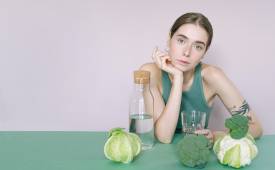 female-vegan-dietary-supplements-vegies-water-on-table