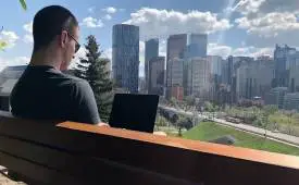 man-freelancer-park-overlooking-city-skyline-land-freelance-writing-clients