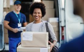happy-african-american-woman-holding-delivered-packages-couriers-is-standing-background
