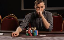 man-thinking-gambling-chips-on-table
