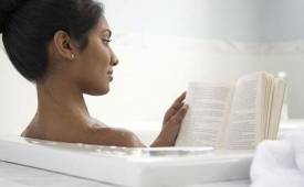 woman-in-bath-reading-book-provide-happiness-boost-as-big-vacations - illustration